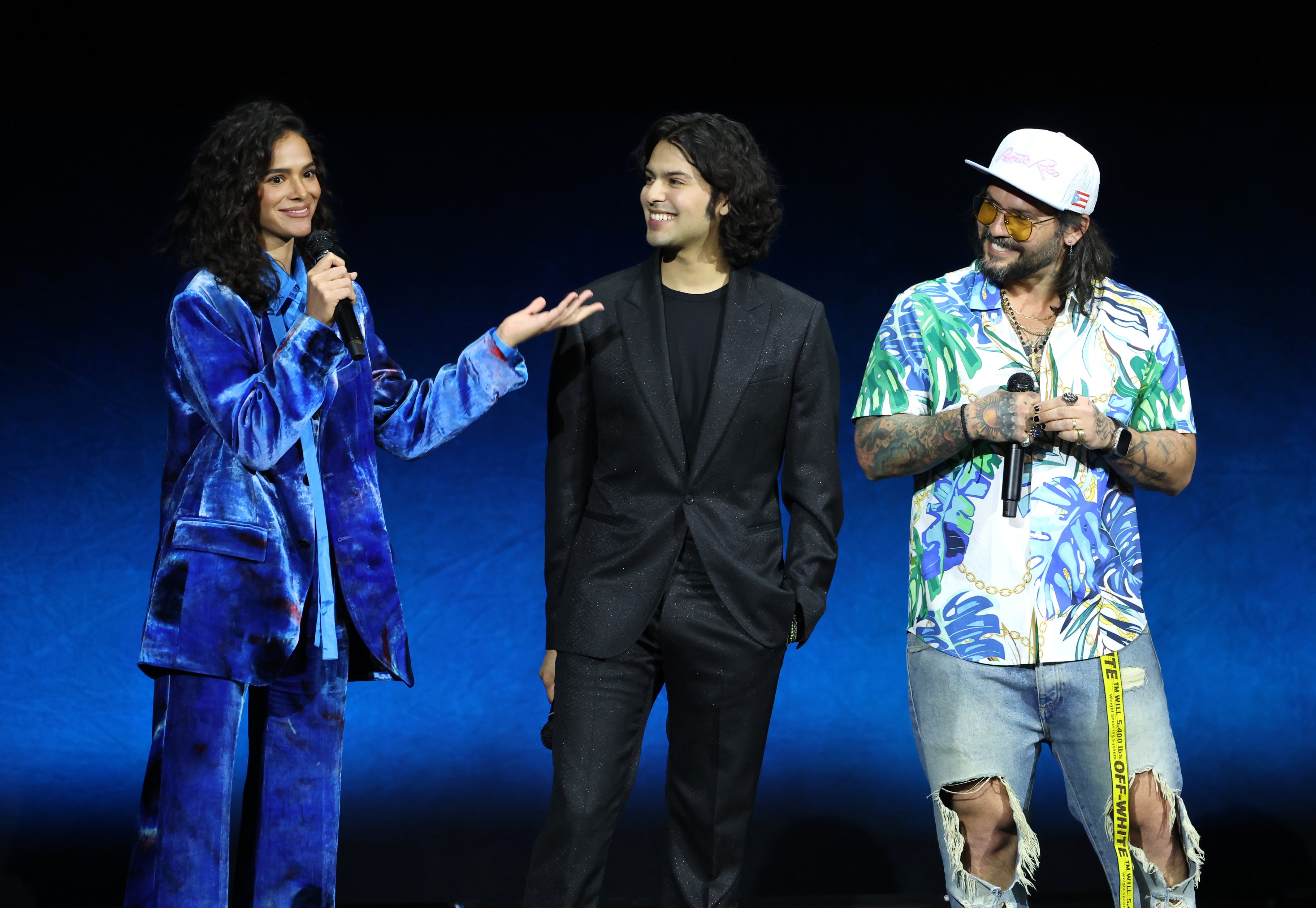 Promotional photo of cast and creators of Blue Beetle on stage