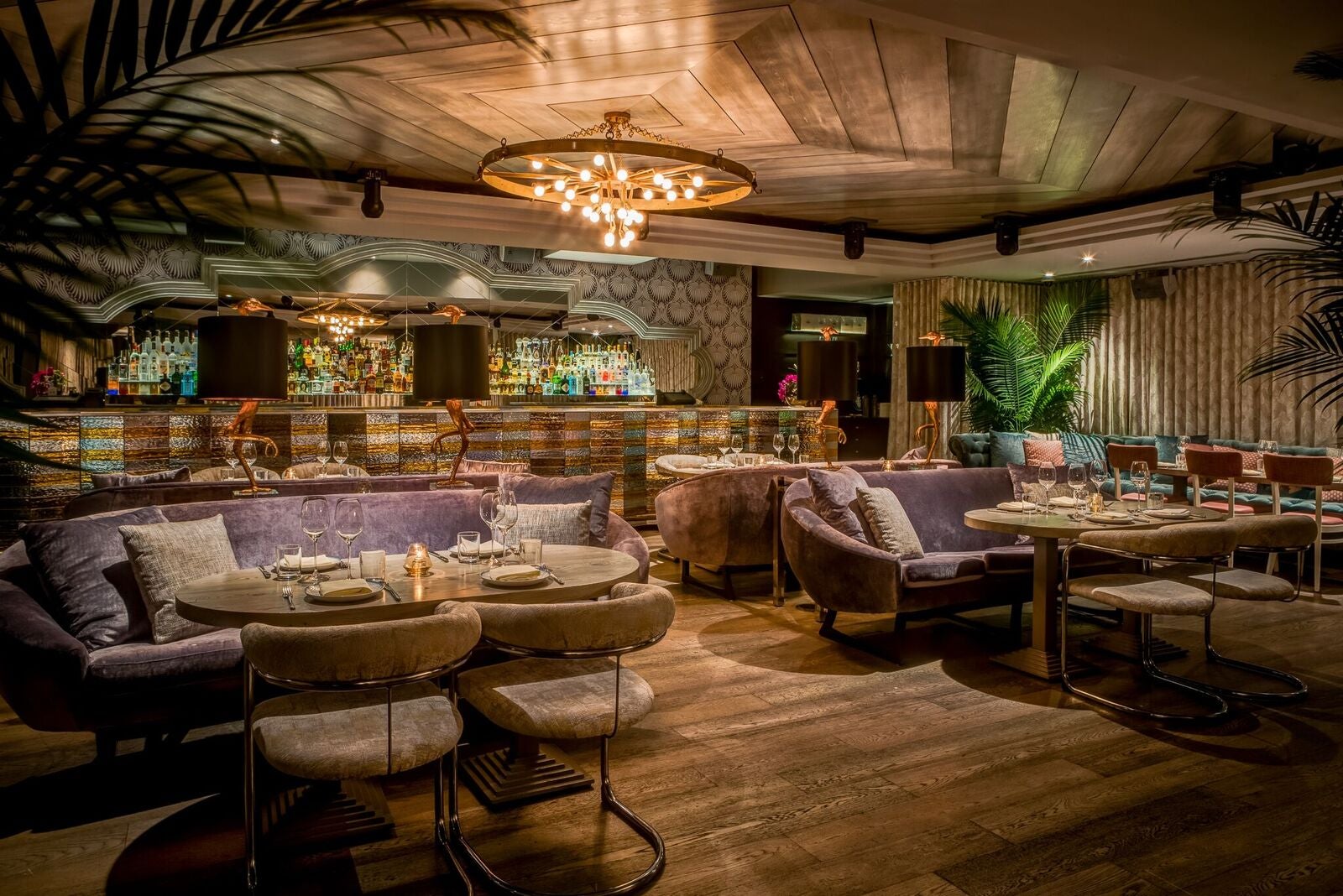 Interior of Byblos Miami, showing couches and tables and a chandelier