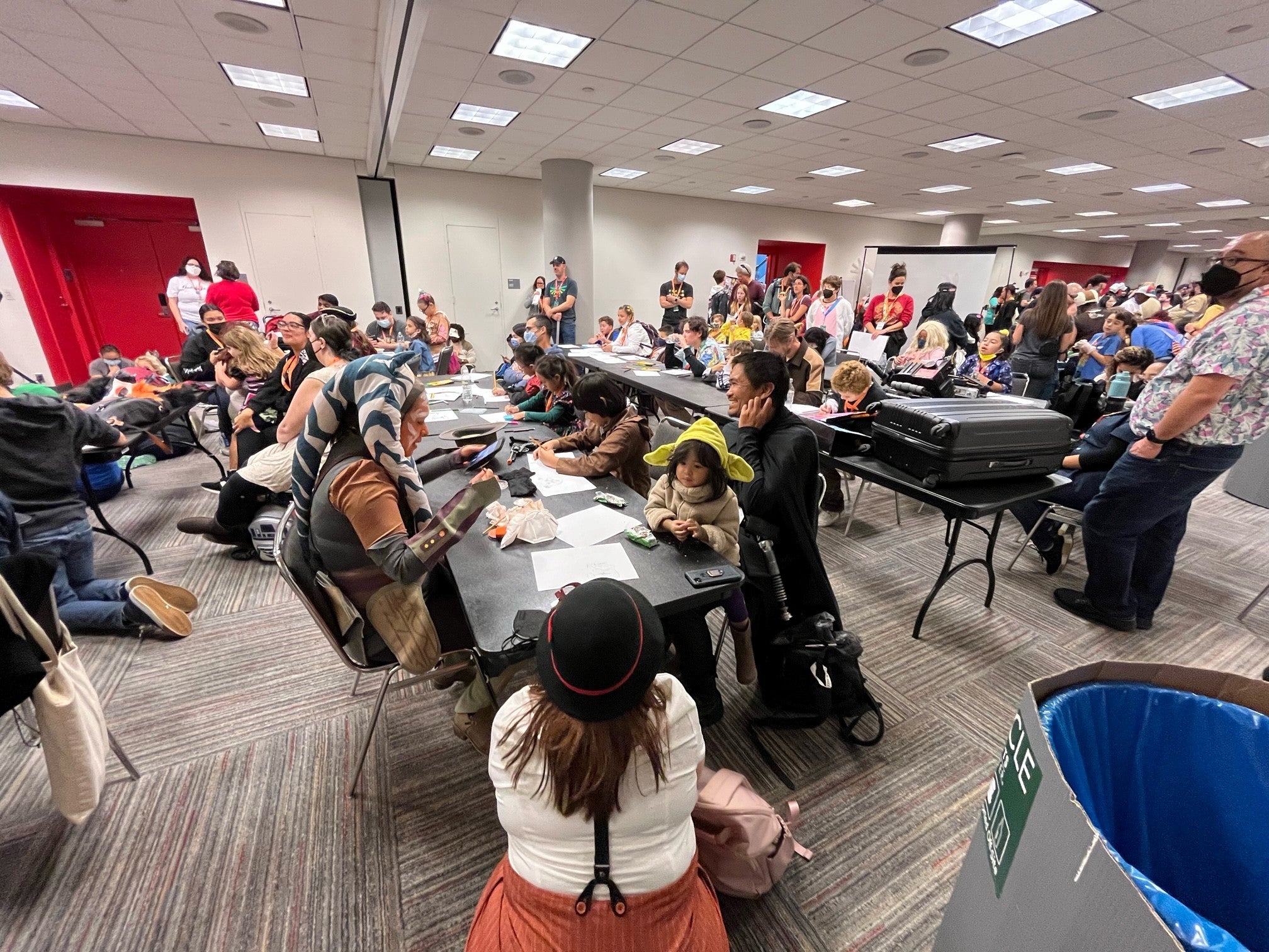 Photograph of a room filled with people drawing