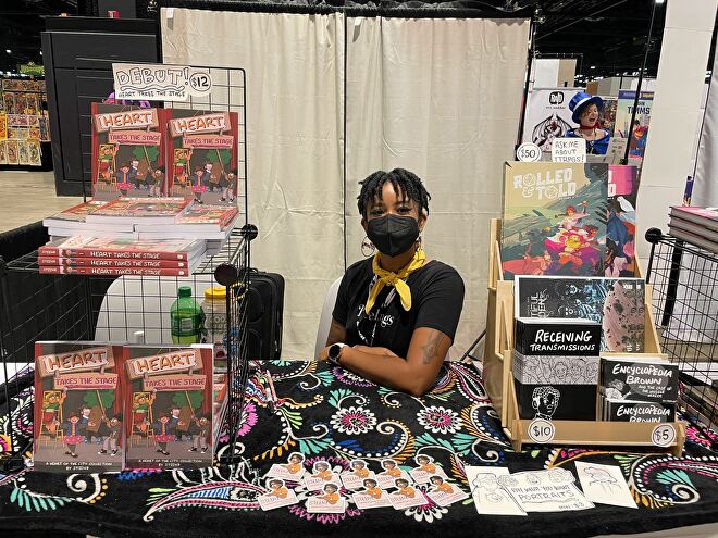 Steenz Stewart sitting behind their booth at C2E2