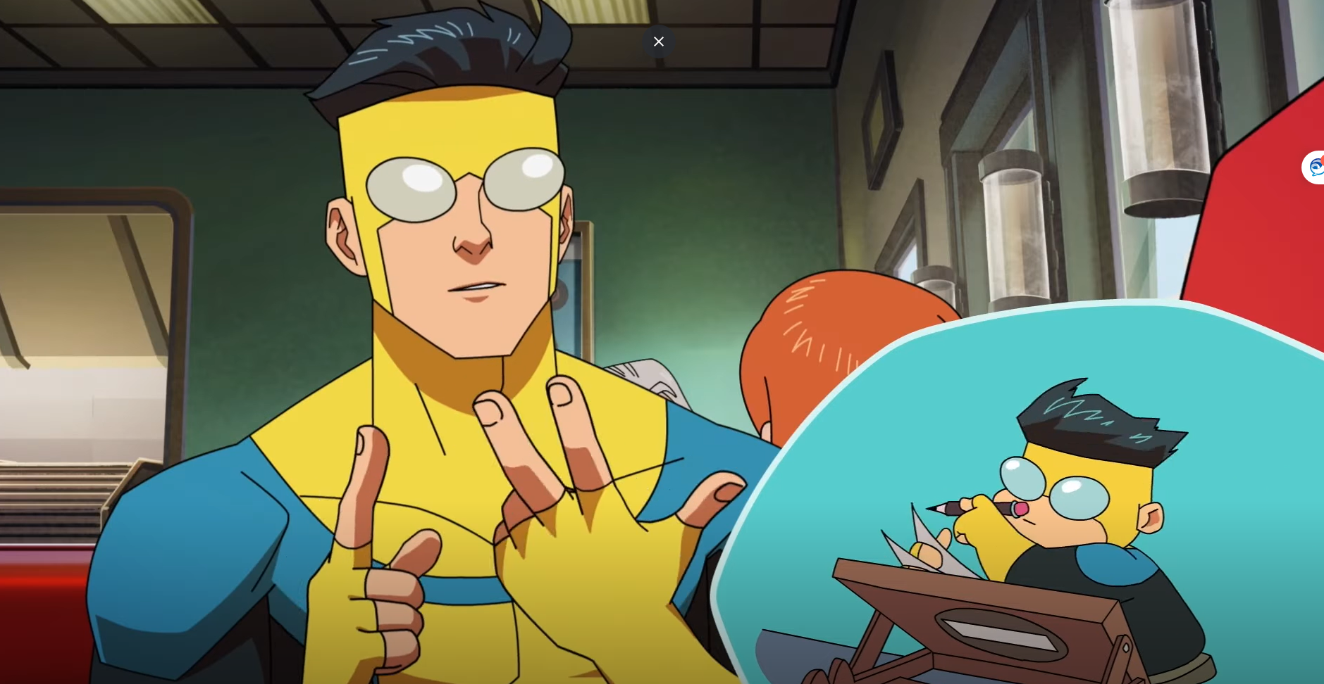 Character in a blue and yellow superhero suit sitting in a diner with a small chibi version drawing at a table