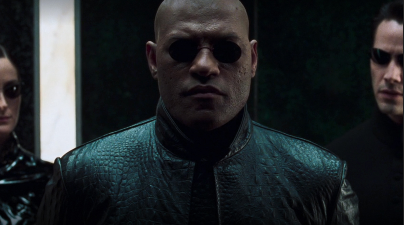 Lawrence Fishburne wearing sunglasses and a leather jacket as Morpheus