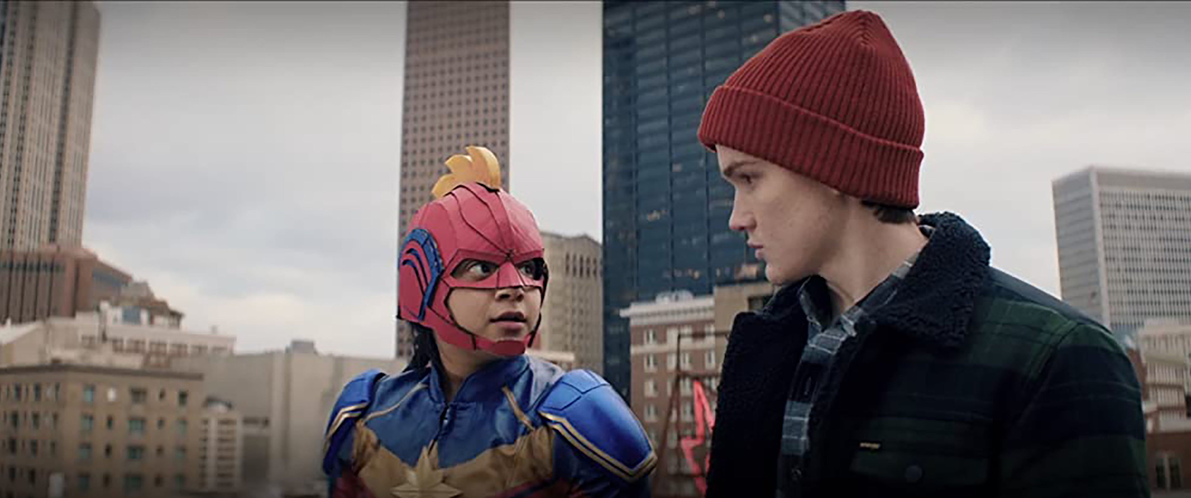 Ms. Marvel still Iman Vellani as Kamala Khan in Ms. Marvel costume standing next to Matt Lintz as Bruno Carrelli