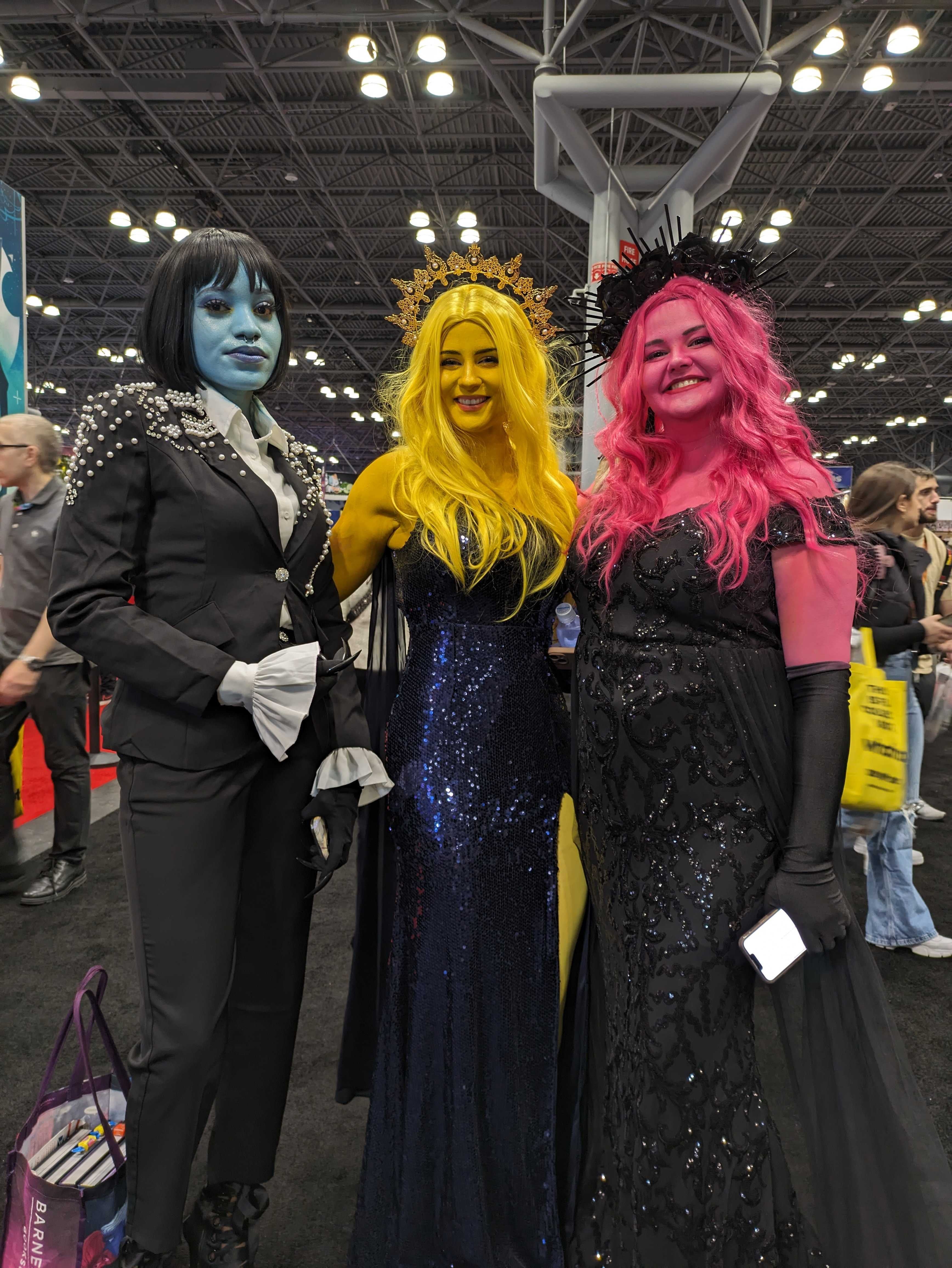 Photo of three Lore Olympus cosplayers