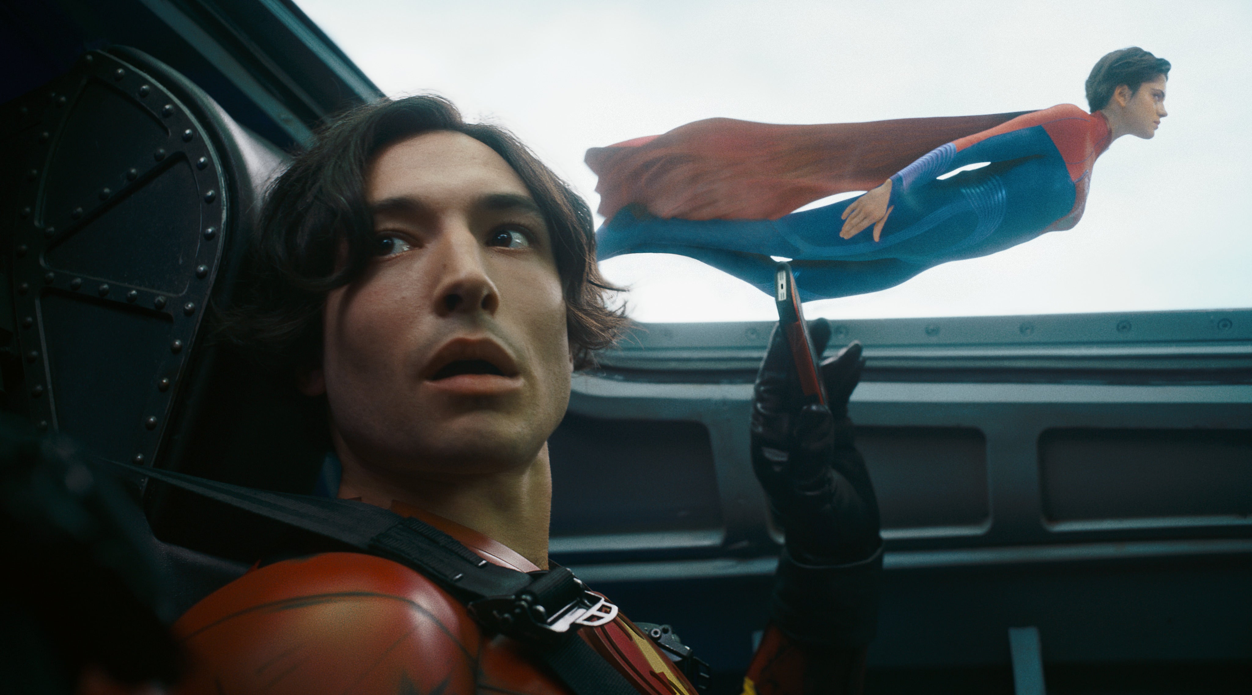 Still production photo featuring Barry Allen looking out at Supergirl